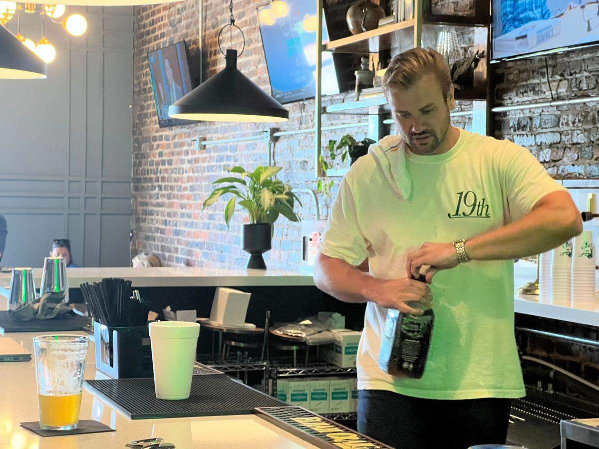 Co-owner and general Charles Coulson makes a drink at 19th at the Warehouses.
