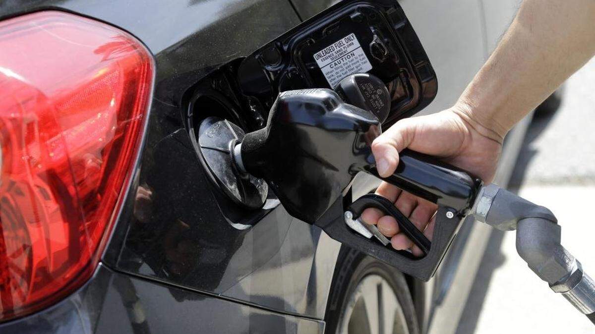 FILE - In this May 8, 2015, file photo, gas station attendant Carlos Macar pumps gas in Andover, Mass. Oil prices have plummeted over the last year, a result of high global supplies and weaker demand than expected. U.S. drivers are paying less than $2 a gallon on average for the first time since the Great Recession. (AP Photo/Elise Amendola, File)