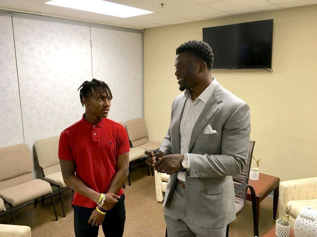 Benjamin Watson meets with a fan before a Fellowship of Christian Athletes fundraiser in Lancaster in April 2018. The former Northwestern Trojan football standout has re-signed with the New England Patriots.
