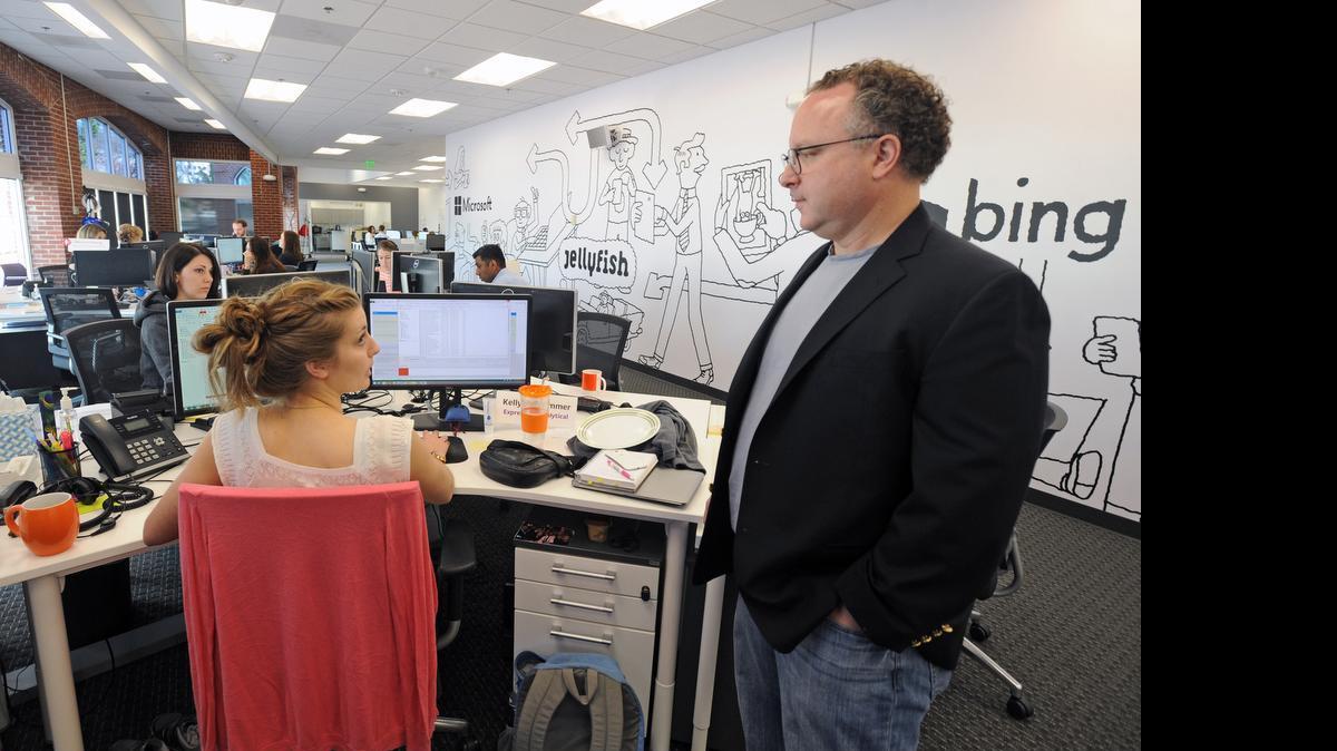 
Kevin Buerger, right, executive VP of Jellyfish, a UK-based Internet marketing company, talks with Kelly Pollhammer at the company’s U.S. headquarters in Baltimore. The company has grown from a one-man shop to more than 60 employees and $100 million in revenue. 
