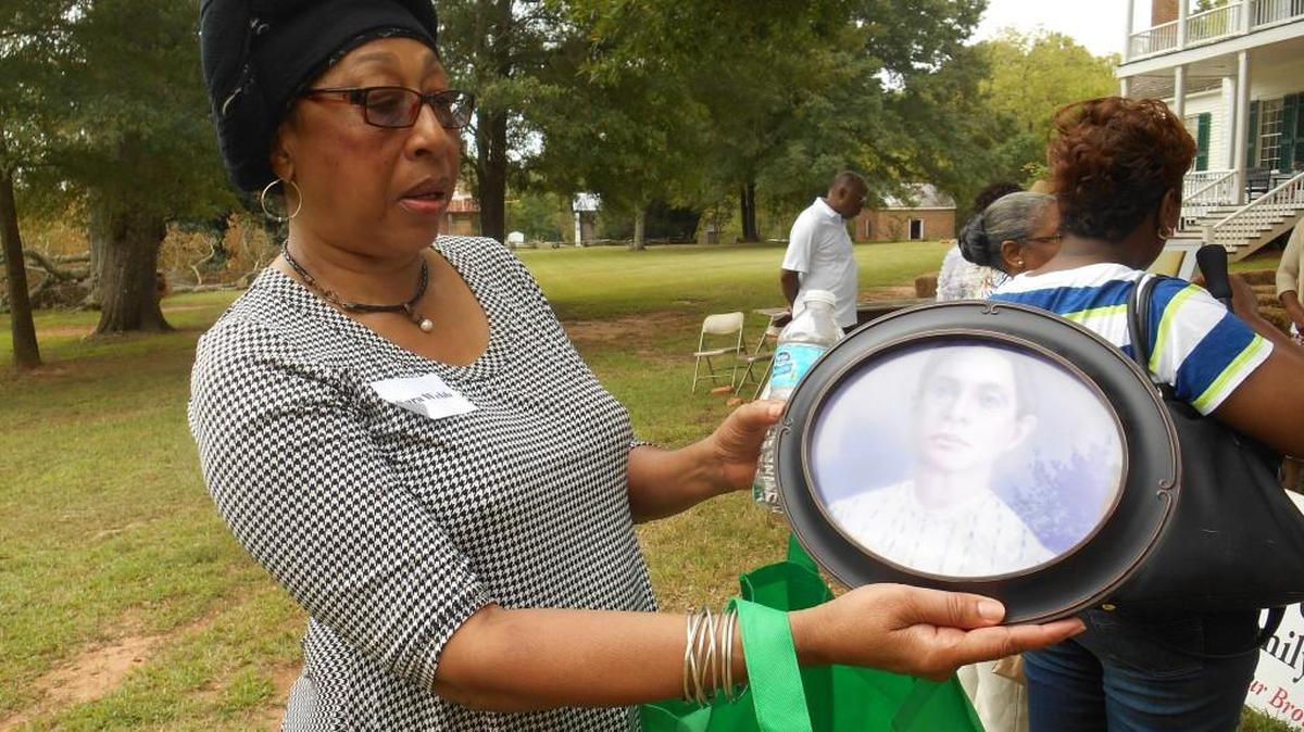 Descendant Sara Webb looks through photographs and heirlooms on display at Historic Brattonsville’s “By the Sweat of Our Brows.”