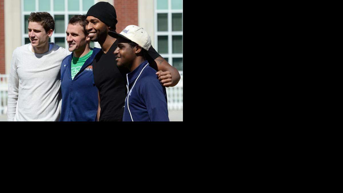 
Yannick Stubbe, left, and Avery Cypress, right, get their photo taken with swimmers Ryan Lochte and Cullen Jones on the Queens University of Charlotte campus last weekend.

