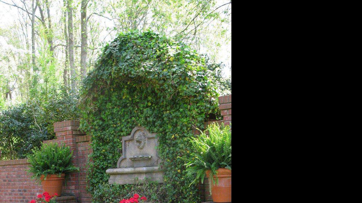 
A lionhead fountain dominates the walled garden at Kim and Mike Climer’s home.
