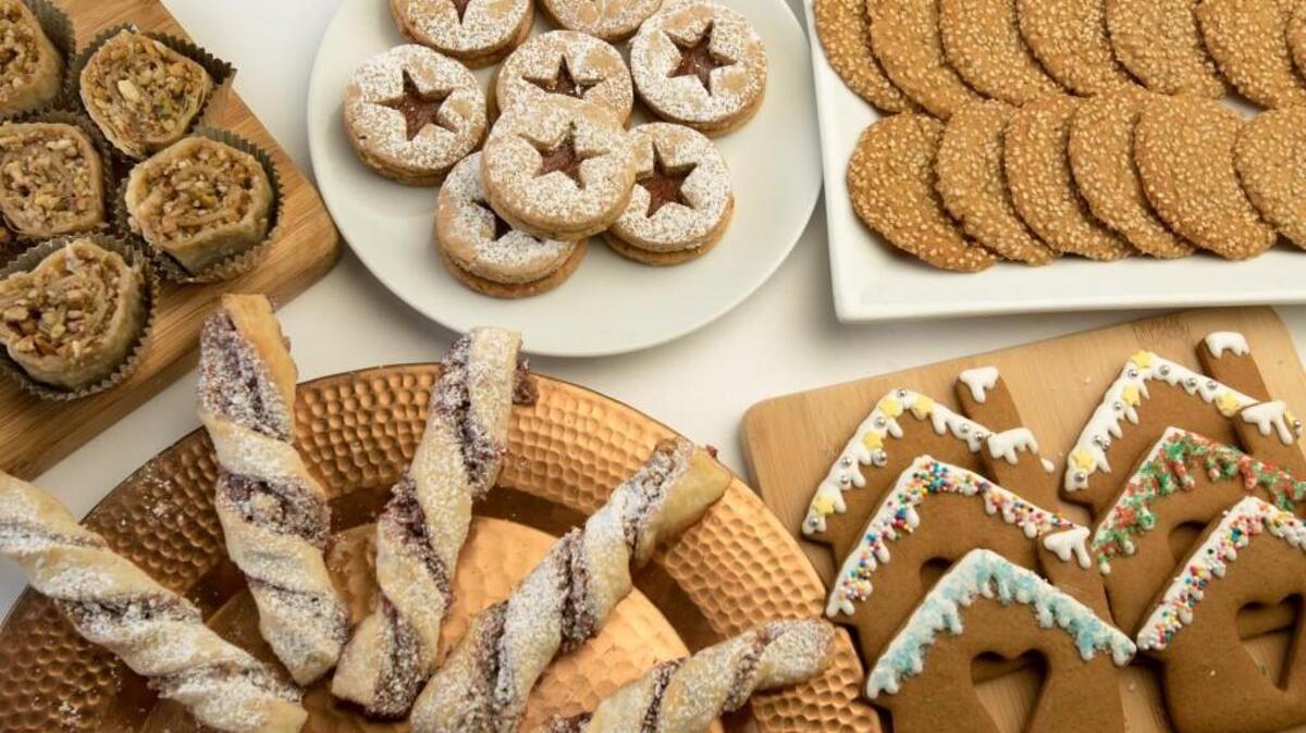The finalists’ cookies from the Seventh Annual Cookie Bake-off. Clockwise from the top: Linzer cookies with persimmon filling, tahini shortbread cookies, gingerbread heart house cookies, French twists and baklava roulade cookies.