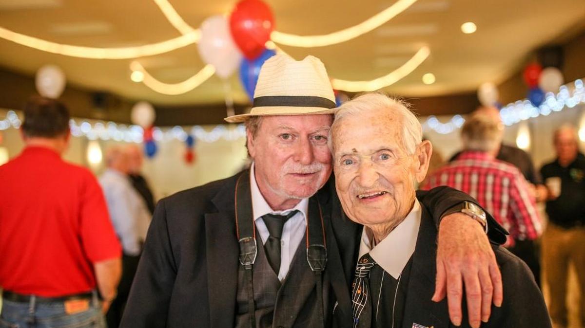 Tom Wearing takes a photo with his dad, John Wearing, during his life celebration at the Bruce VFW Post in St. Clair Shores, Mich. John was diagnosed with terminal cancer.