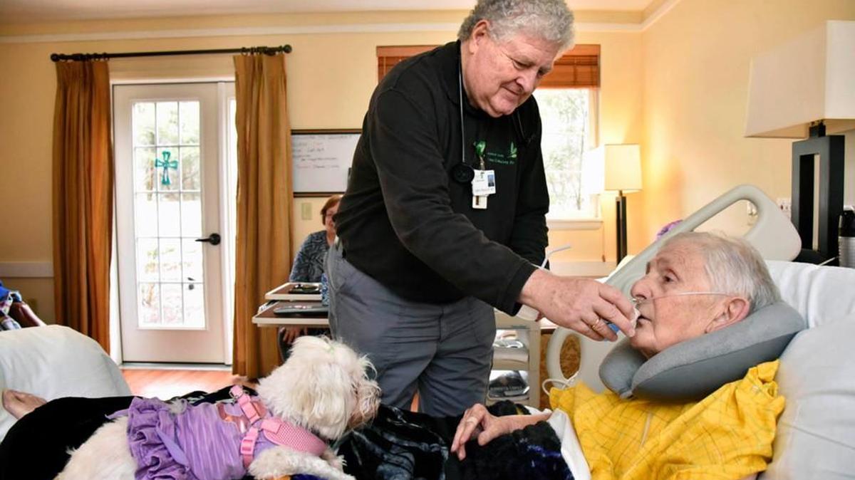 John O’Malley, RN, gives Richard Gottal, 75, medicine.