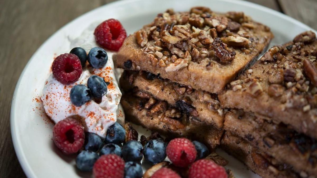French toast gets a twist from Swedish limpa bread, chopped pecans, maple syrup-infused whipped cream and a dash of cayenne.