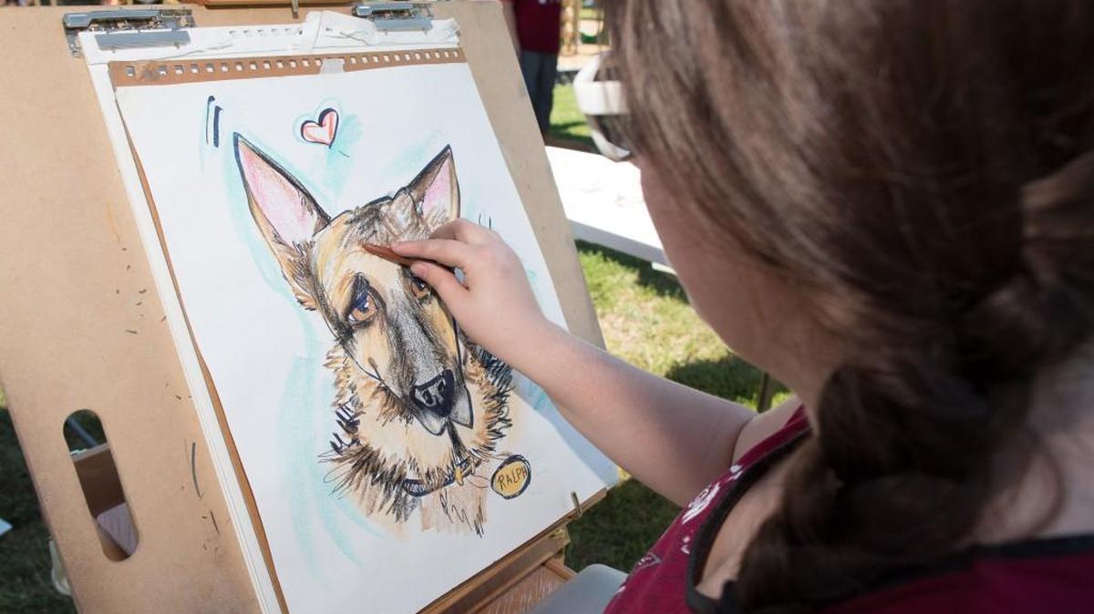 Alysa Smith draws a caricature of Ralph at last year’s Humane Society of York County’s Dog Gone Good Festival at Walter Elisha Park in Fort Mill. This year’s festival is Saturday.