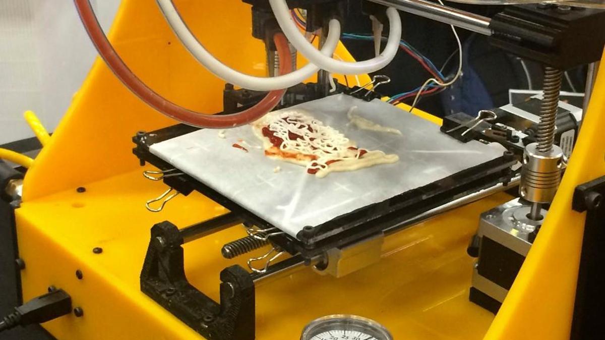 A 3-D printer makes tiny pizzas in the shape of the United States at South by Southwest’s trade show last week. The printer was designed by Anjan Contractor, a Houston inventor and mechanical engineer.