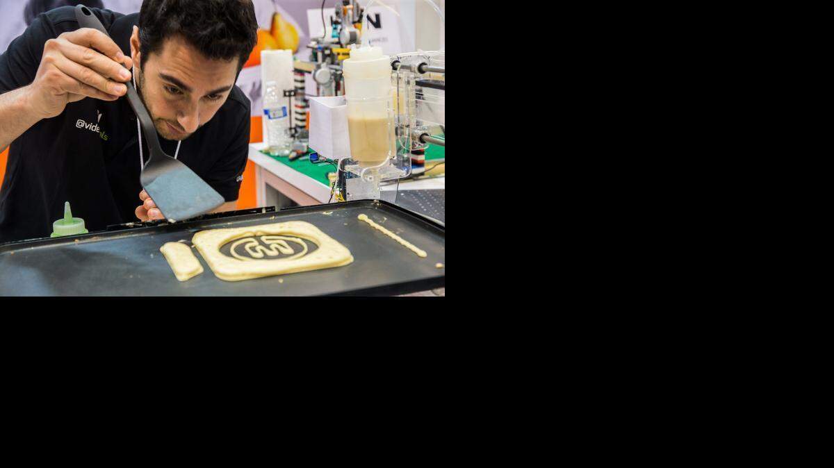 
Slim Geransar demonstrates PancakeBot at the Storebound booth at the International Housewares Show in Chicago. 
