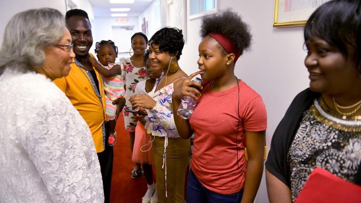 Rev. Mary Fowler, left, talks with members of the Youth Choir including from left, choir director Mario Wilson, Rikia Wilson, 14, Dania Wilson, 9, Antia Wilson, 16, and Mia Wilson, 11, as well as Linda Williams, right, before services at the church she started 20 years ago when became a pastor at 63 at Mary's Missionary Baptist Church.