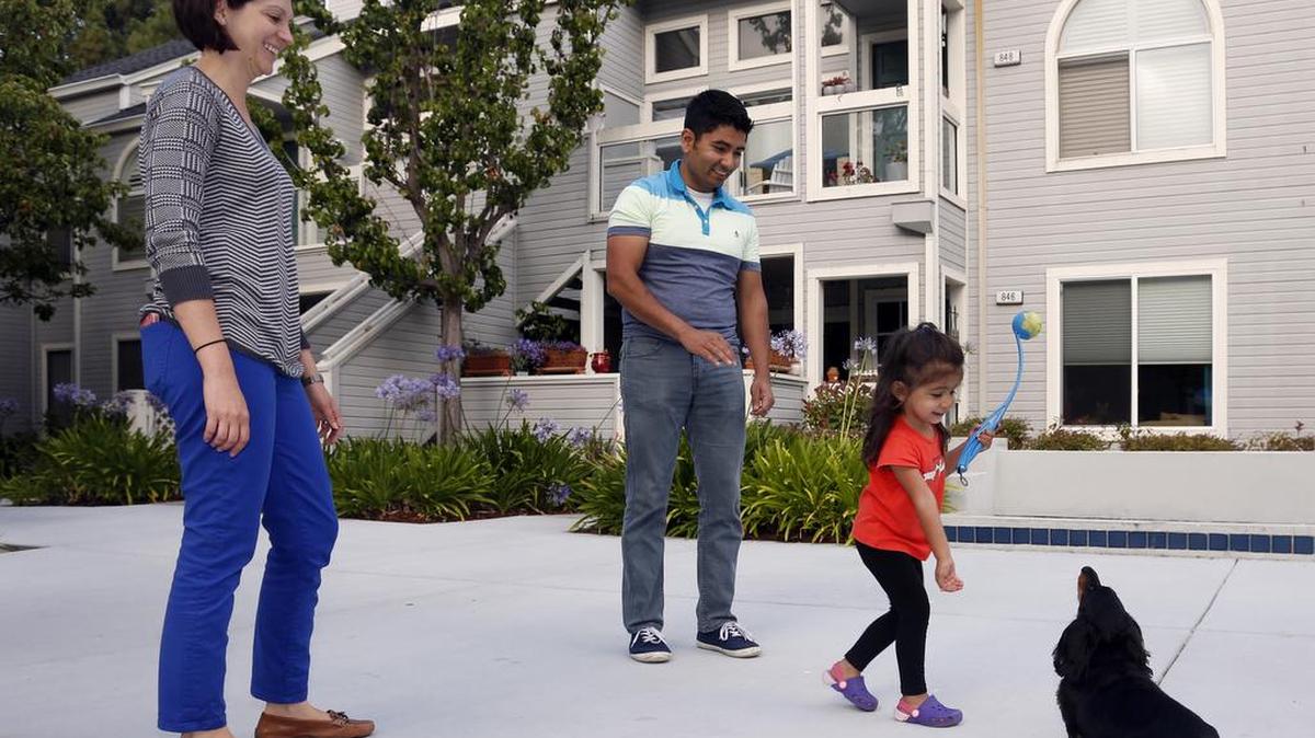 
Sarvesh and Cristina Regmi play with their 2-year-old daughter, Elina, outside their home in Redwood Shores, Calif. The couple used the web-based mortgage refinancing platform Lenda to refinance their home. 
