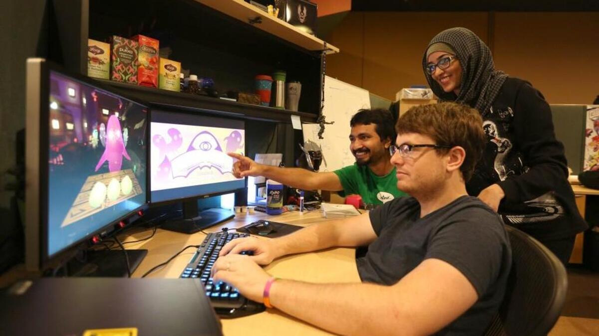 Nihav Jain, from left, Summan Mirza and Derek Mattson pose for a photo. Using hardware available for game developers, the UCF group has created a game that tracks a player’s eyes and translates that to movement on the screen.