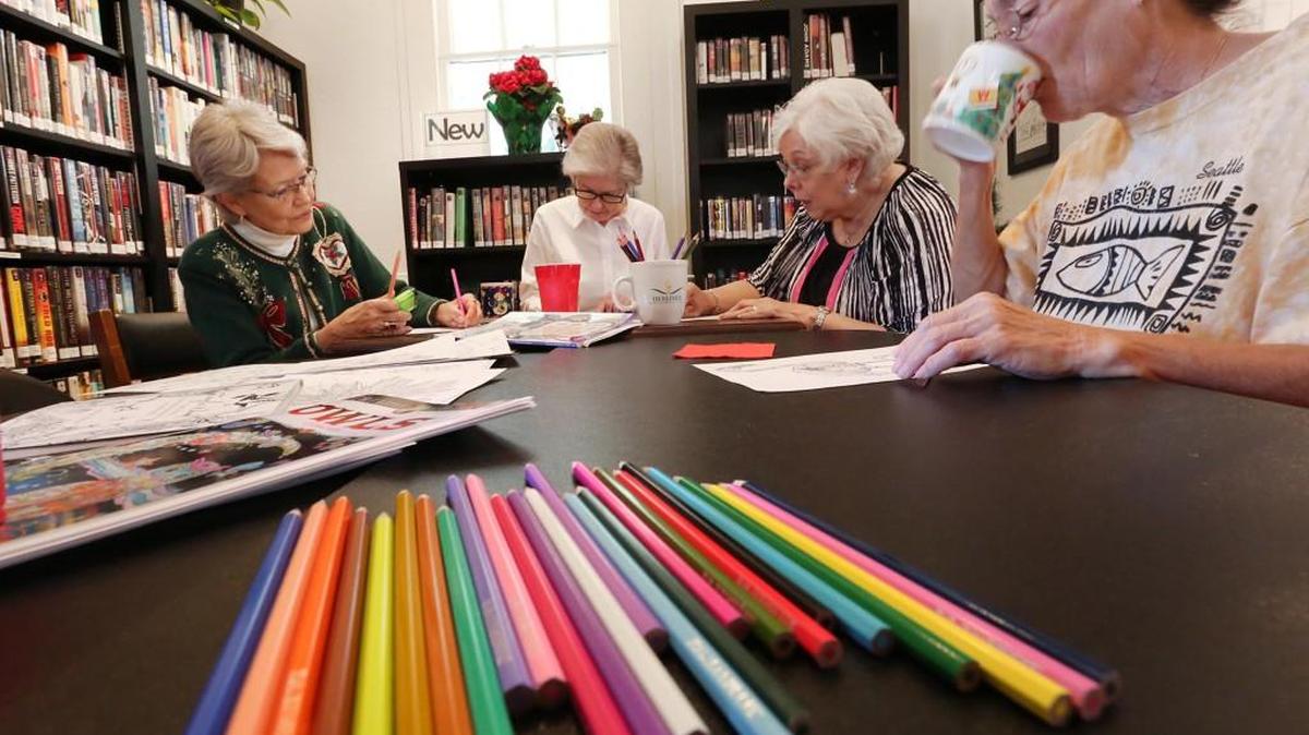 Diane Merchant, Mary Ellen MacKay, Sharon Scott, and Rae Menke, left to right, color during a “Color Me Calm” adult coloring event at the Minneola Schoolhouse Library.