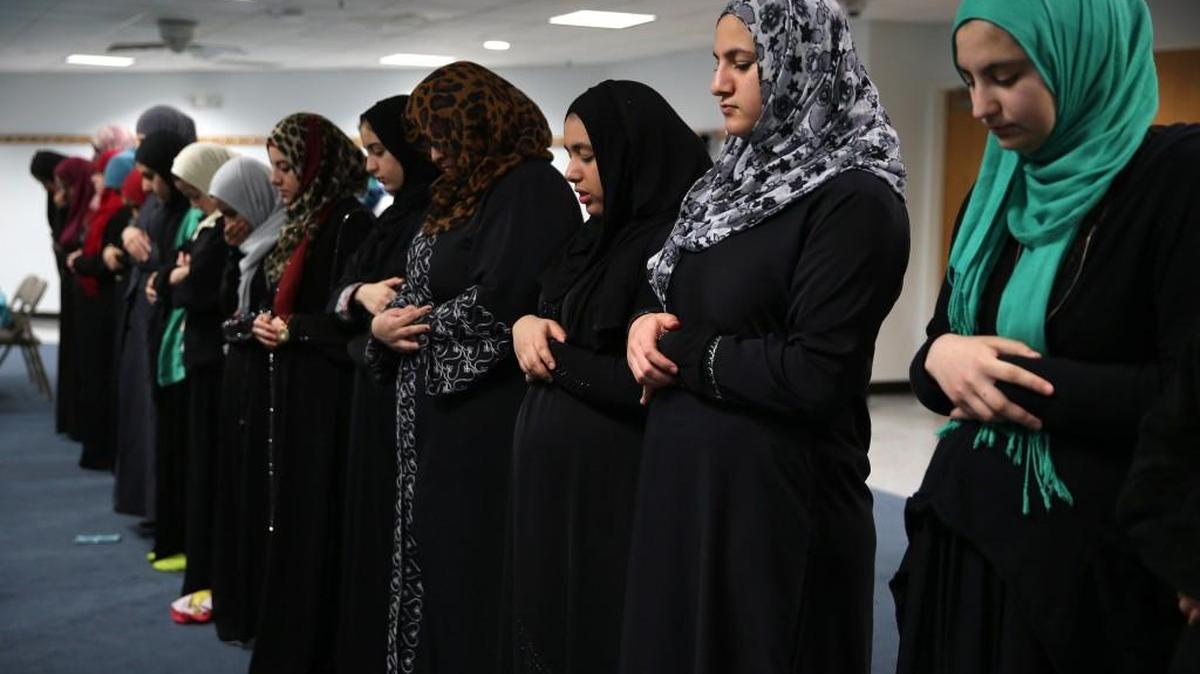 Girls close the night with a prayer after participating in Friday Night lives at the Prayer Center in Orland Park, Ill., a weekly program for teens to talk and share their experiences.