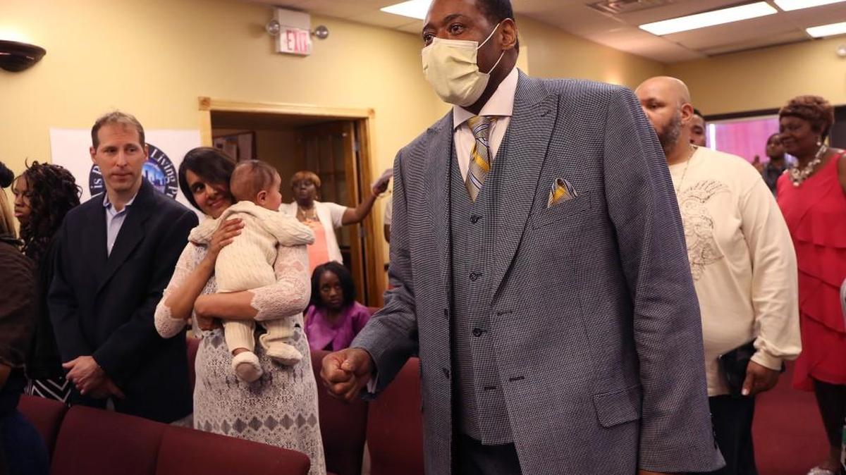 Rev. Joseph Kyles enters his church March 27 to preach for the first time after his double lung transplant at The Promise Church of Chicago in Chicago. At left are Dr. James Gagermeier, part of the lung transplant team at Loyola, and his wife Hameeda Shaikh, a pulmonologist with the Edward Hines Jr., VA Hospital and their son Leo.