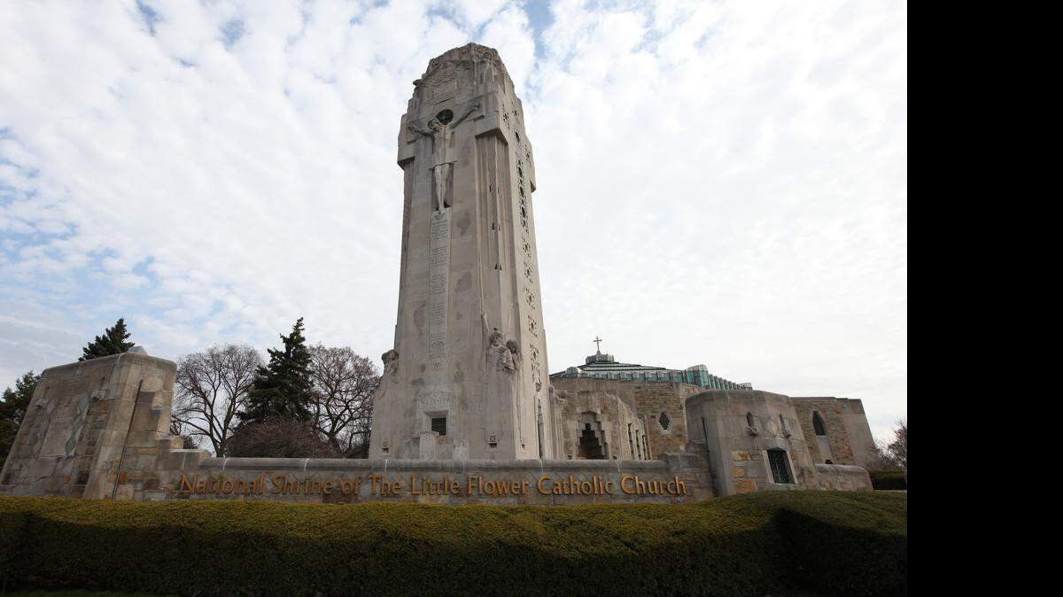 
Limestone Art Deco tower called the Charity Crucifixion Tower, completed in 1931, features integrated figural sculptures by Rene Paul Chambellan, including a large figure of Christ on the cross, 28 feet high on one facade. Built in response to the Ku Klux Klan as a “cross they could not burn,” at the National Shrine of the Little Flower Roman Catholic Church in Royal Oak, Mich. 
