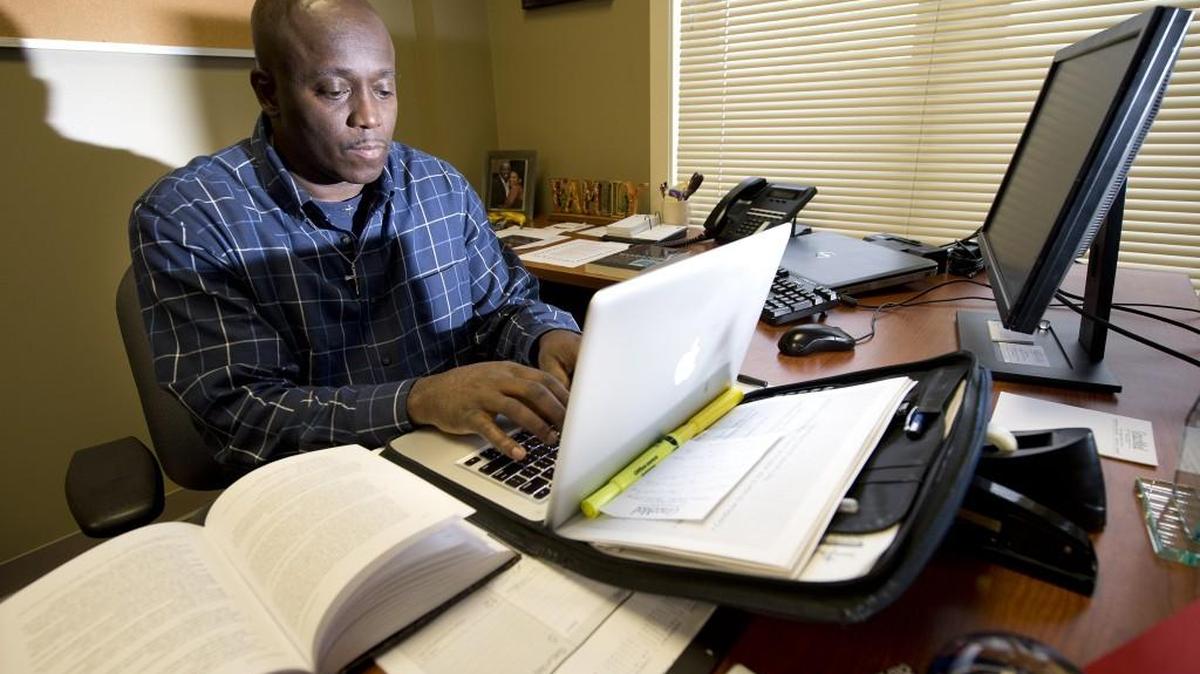 Darryl A. Burton, 54, a student at St. Paul’s School of Theology, works on a paper on The Order of Worship, in his office at Church of the Resurrection in Leawood, Kan.