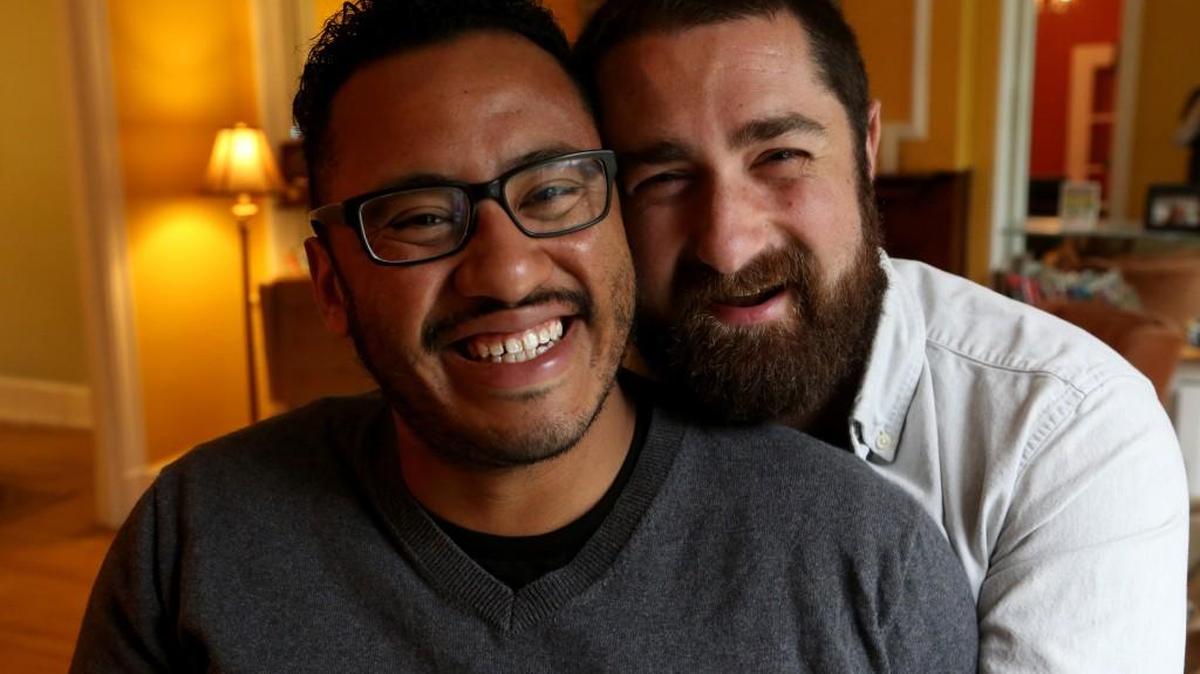 Tom Molina-Duarte, left, 28 and husband Bryan Victor, 30, pose for a portrait in their Detroit, Mich., home. The couple married in August but had been dating four years prior.