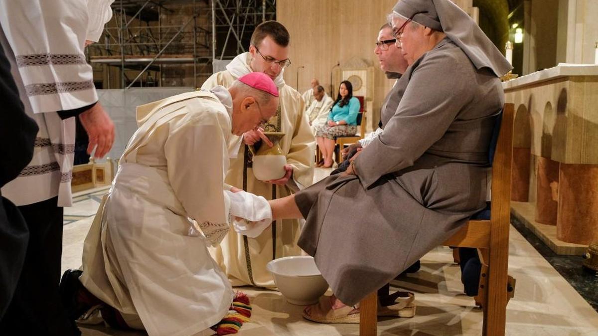 Archbishop Carlo Maria Vigano, the Vatican's ambassador to the U.S., washes the foot of Sister Antonia Sanchez at the Basilica of the National Shrine of the Immaculate Conception on Holy Thursday in Washington. It marked the first time the Basilica included women in the annual ceremony.