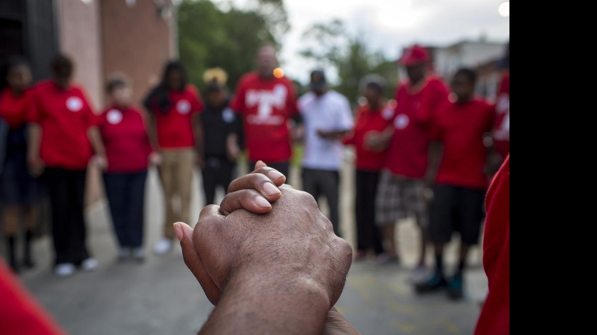 
Members of the St. Martin de Porres congregation join in prayer at Laramie Avenue and Adams Street in Chicago. 
