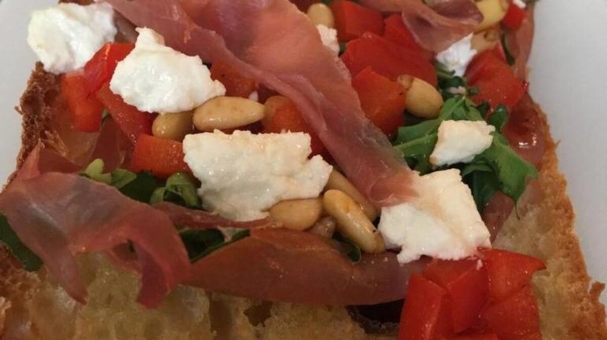 Goat cheese, red pepper, pine nut and prosciutto pizza on toasted ciabatta.
