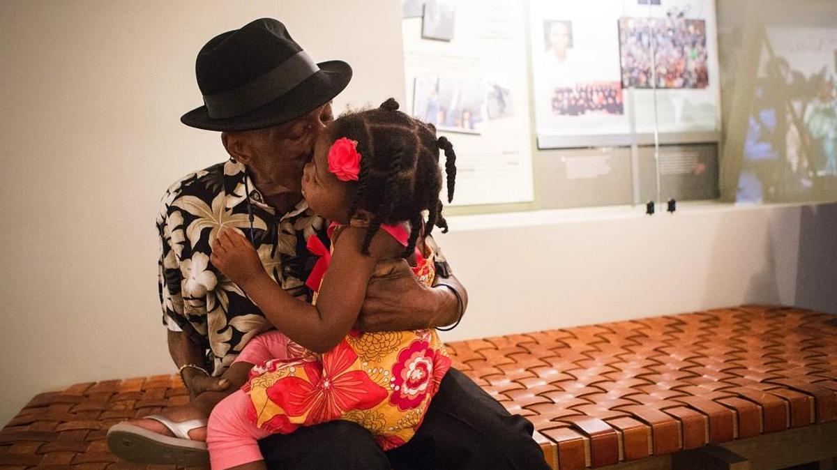 Wilson McLaurin kisses daughter Mariah Weatherby, 3, on the cheek as they visit the Northwest African American Museum. Wilson McLaurin who got clean and sober to try to regain custody of Mariah is now dying of pancreatic cancer.