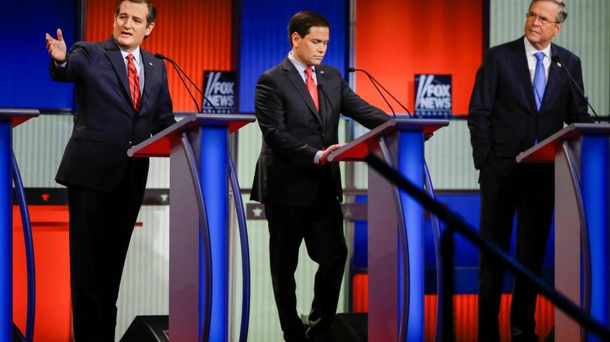 Republican presidential candidate Sen. Ted Cruz, R-Texas, left, answers a question as Sen. Marco Rubio, R-Fla., center, listens and former Florida Gov. Jeb Bush, right, looks on during a Republican presidential primary debate, Thursday, Jan. 28, 2016, in Des Moines, Iowa. (AP Photo/Charlie Neibergall)