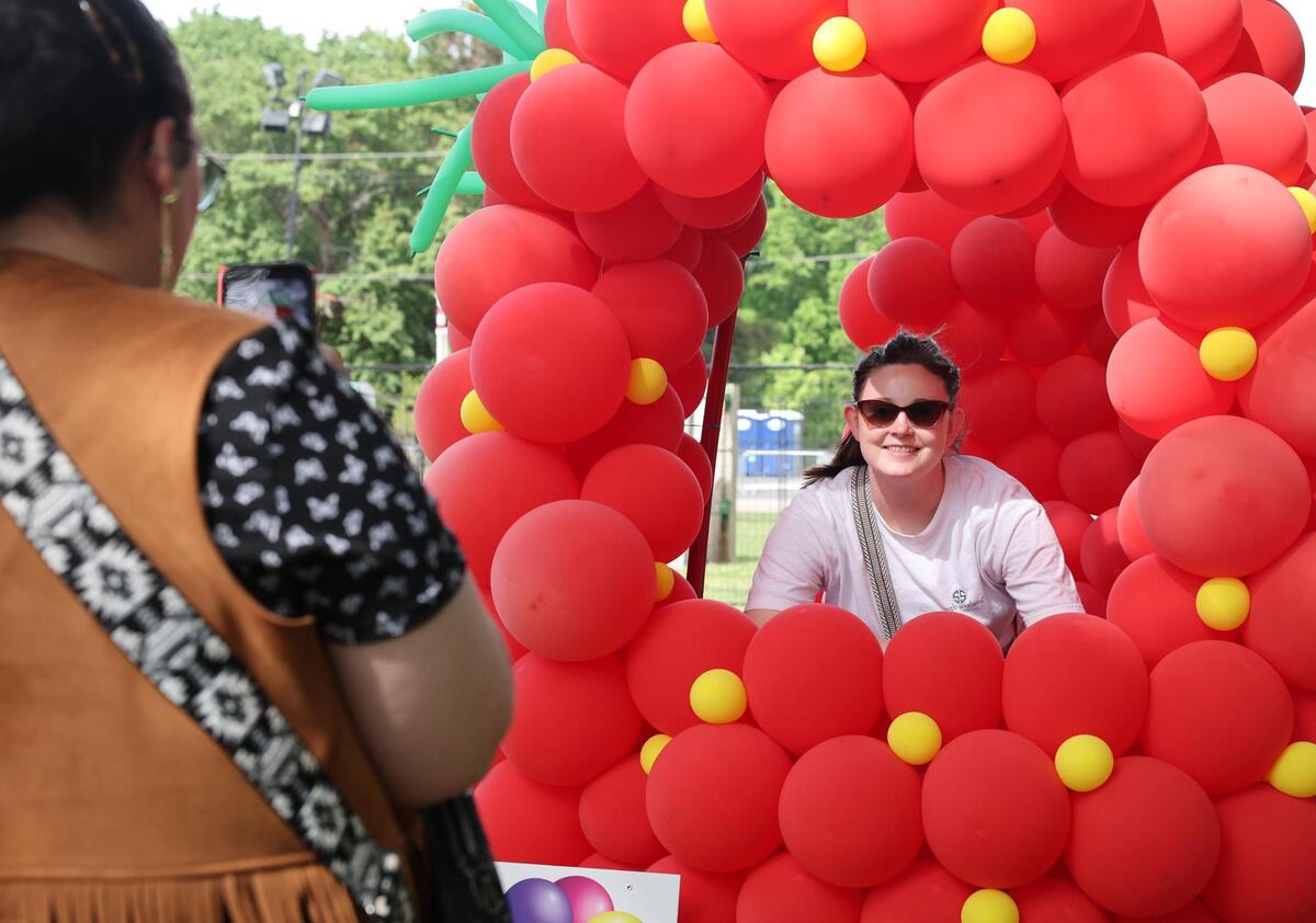 Emily Ramsey poses for a photo inside strawberry-shaped balloons Friday, May 2, 2025 as Larissa Talley snaps a picture.