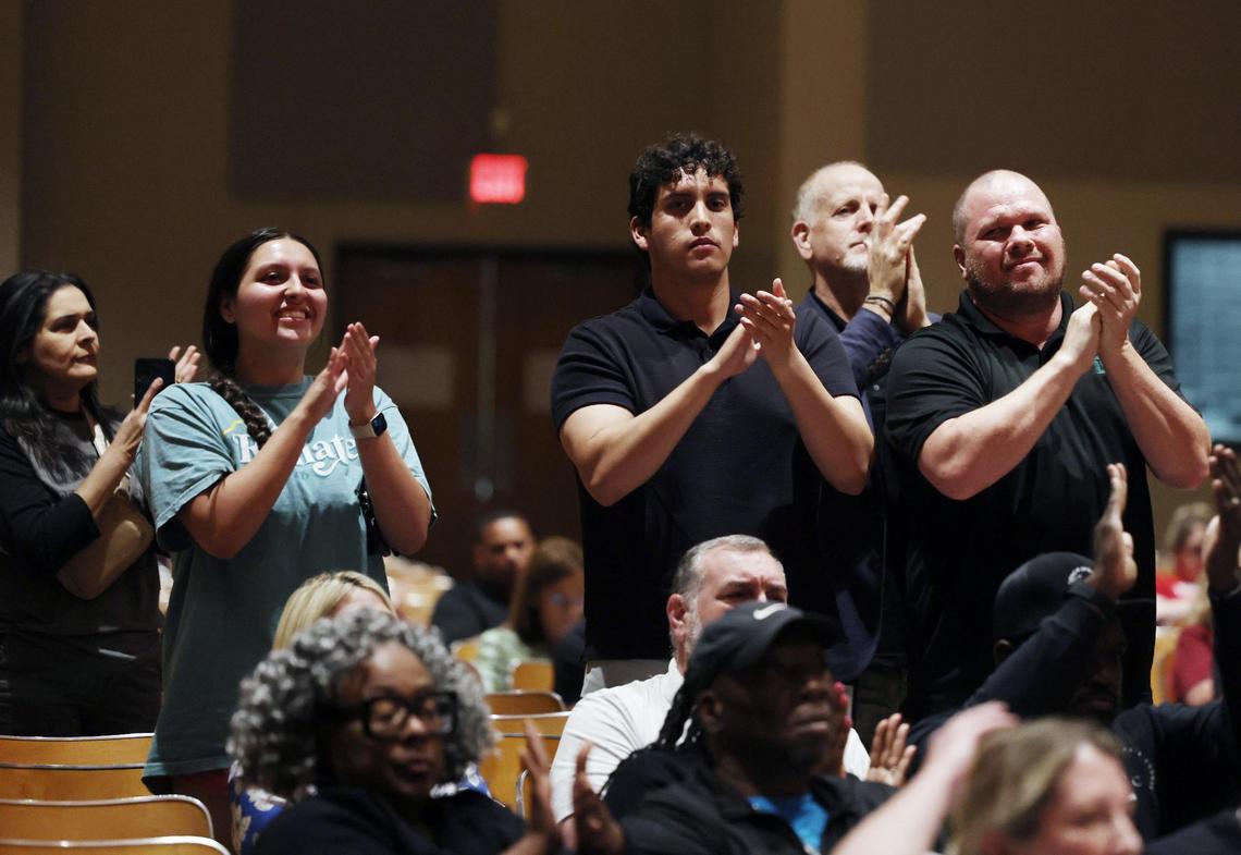 Supporters of Clayton Moton, Dutchman Creek principal, clap Tuesday at the Rock Hill School Board meeting at Sullivan Middle School.