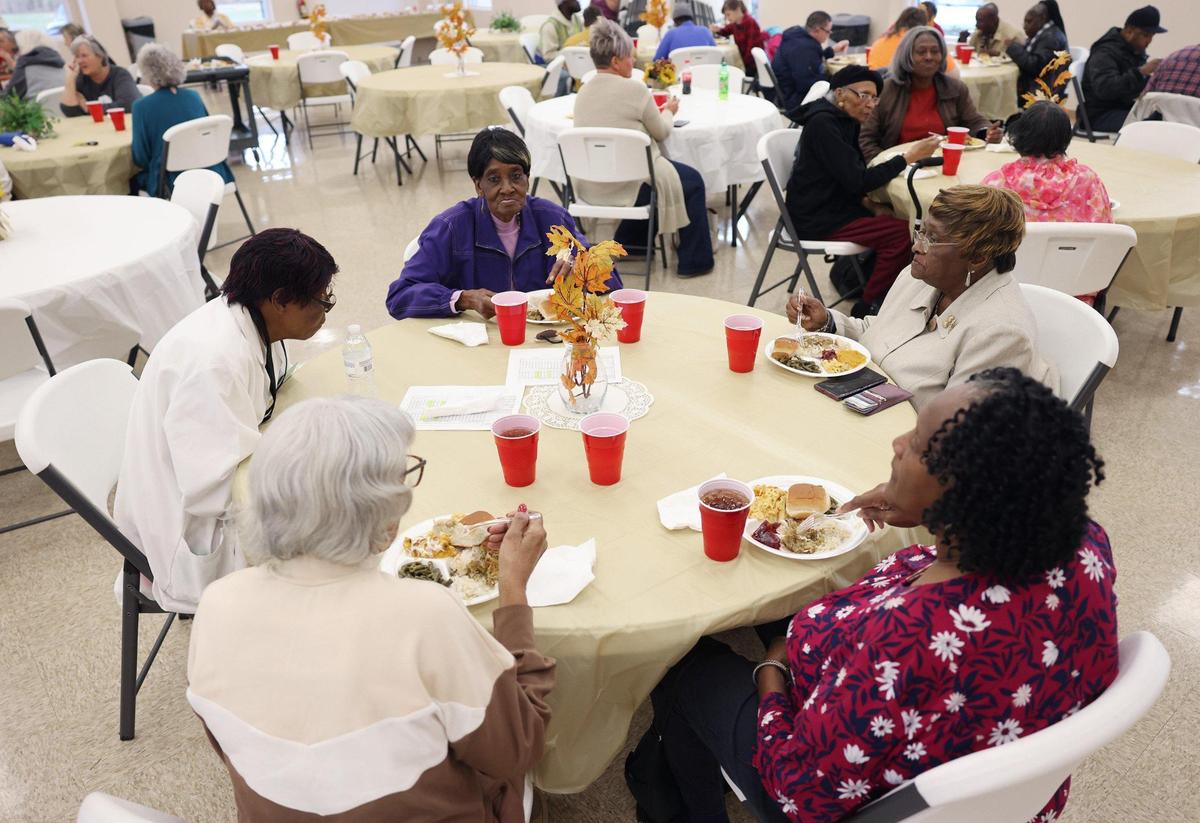 A group of women eat lunch Tuesday at a pre-Thanksgiving meal at Cedar Grove Baptist Church in Chester.