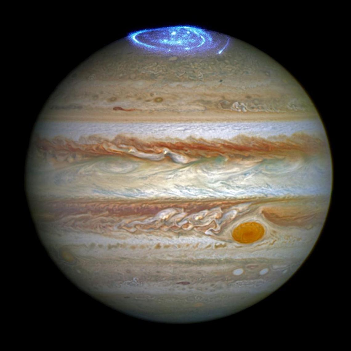 This composite image provided by NASA illustrates auroras on the planet Jupiter. The powerful auroras are sparked by the planet’s own rotation.