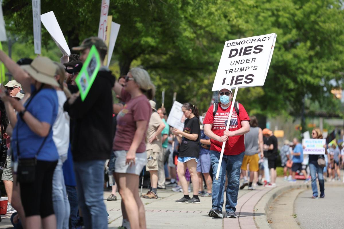 Demonstrators with York County Rising protest President Trump and his policies Sautrday in downtown Rock Hill.