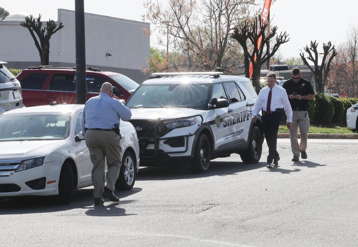 Lancaster Chief of Police Don Roper, left, walks towards Lancaster County Sheriff Barry Faile Tuesday behind the Lancaster Walmart where two people were shot and injured.
