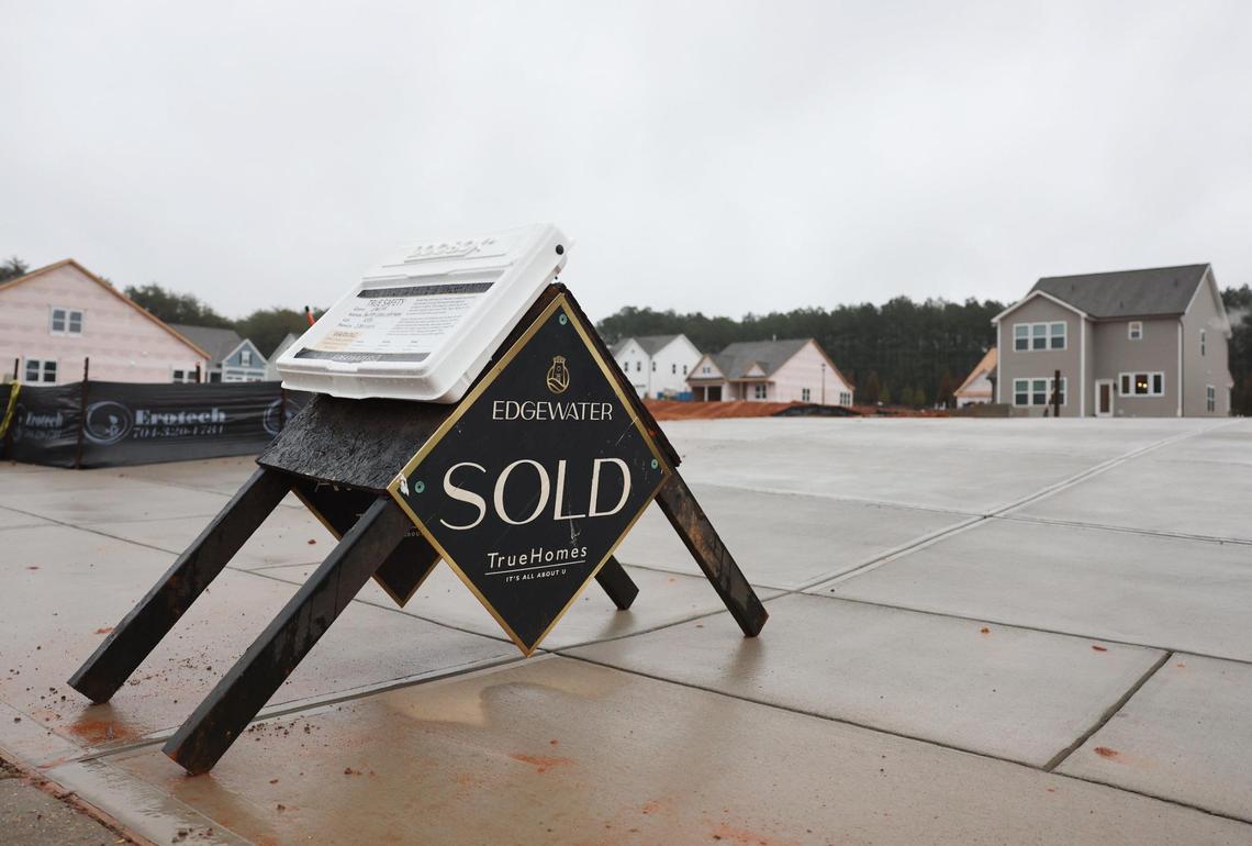 A sold sign sits in the driveway of a future home Tuesday in Edgewater in Lancaster County. Through the end of January, Lancaster County had more than 15,000 home sites approved but not yet built in Edgewater.