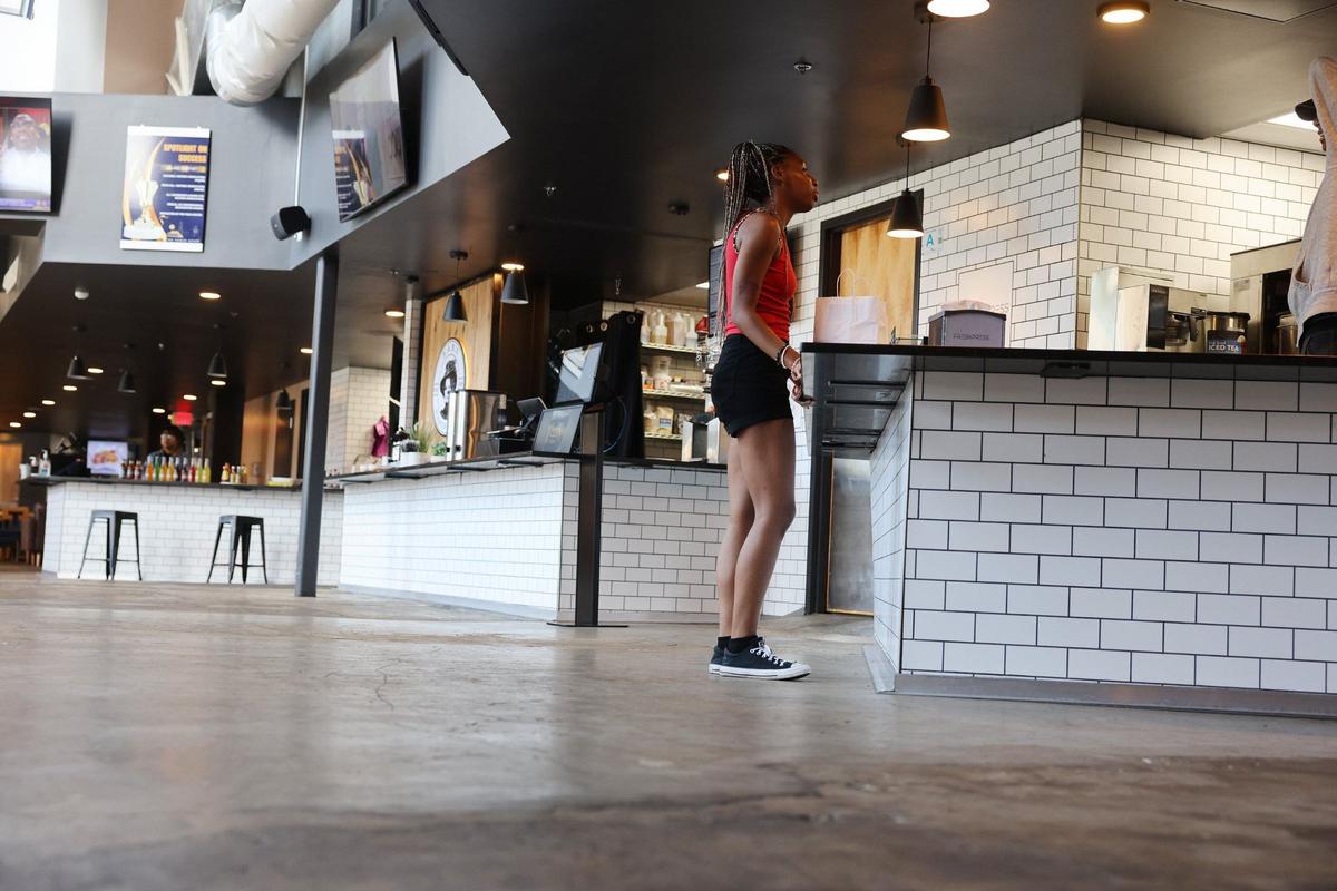 Sunshyne Patterson orders food at a restaurant in The Power House in Rock Hill’s Knowledge Park Friday. The food hall brings on a former white house chef, and will add a coffee place in September.