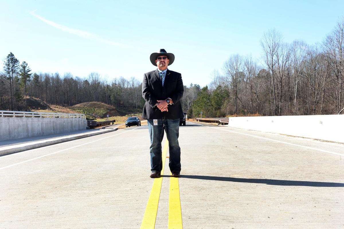 Catawba Indian Chief Brian Harris stands on a new bridge Tuesday near the intersection of Sturgis Road and Rivercrest Road.