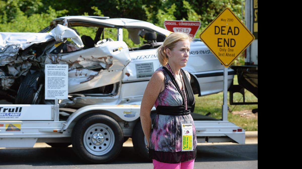 
Executive director of Dying Changes Everything, Tammy Garlock , mother of Brian Garlock who lost his life while using a cell phone while driving address the media. Behind Tammy is a car that was in a crash from distracted driving. This is not the car her son was driving. Continuing its commitment to educate the public on the dangers of distracted driving, AAA Carolinas is announcing a campaign that encourages drivers to stay off their cell phones completely while driving. AAA's latest research into cognitive distractions has shown that using a cell phone while driving can be just as dangerous as drunk driving.

