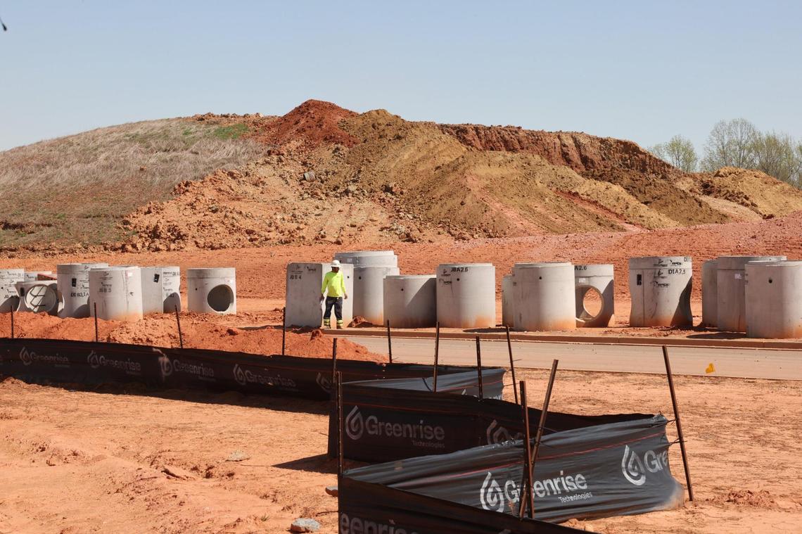 A construction worker stands near a future Costco at The Exchange, a $400 million mix of apartments, townhomes and business space on U.S. 521.