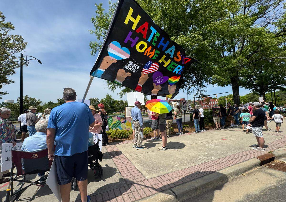Demonstrators with York County Rising protest President Trump and his policies Sautrday in downtown Rock Hill.
