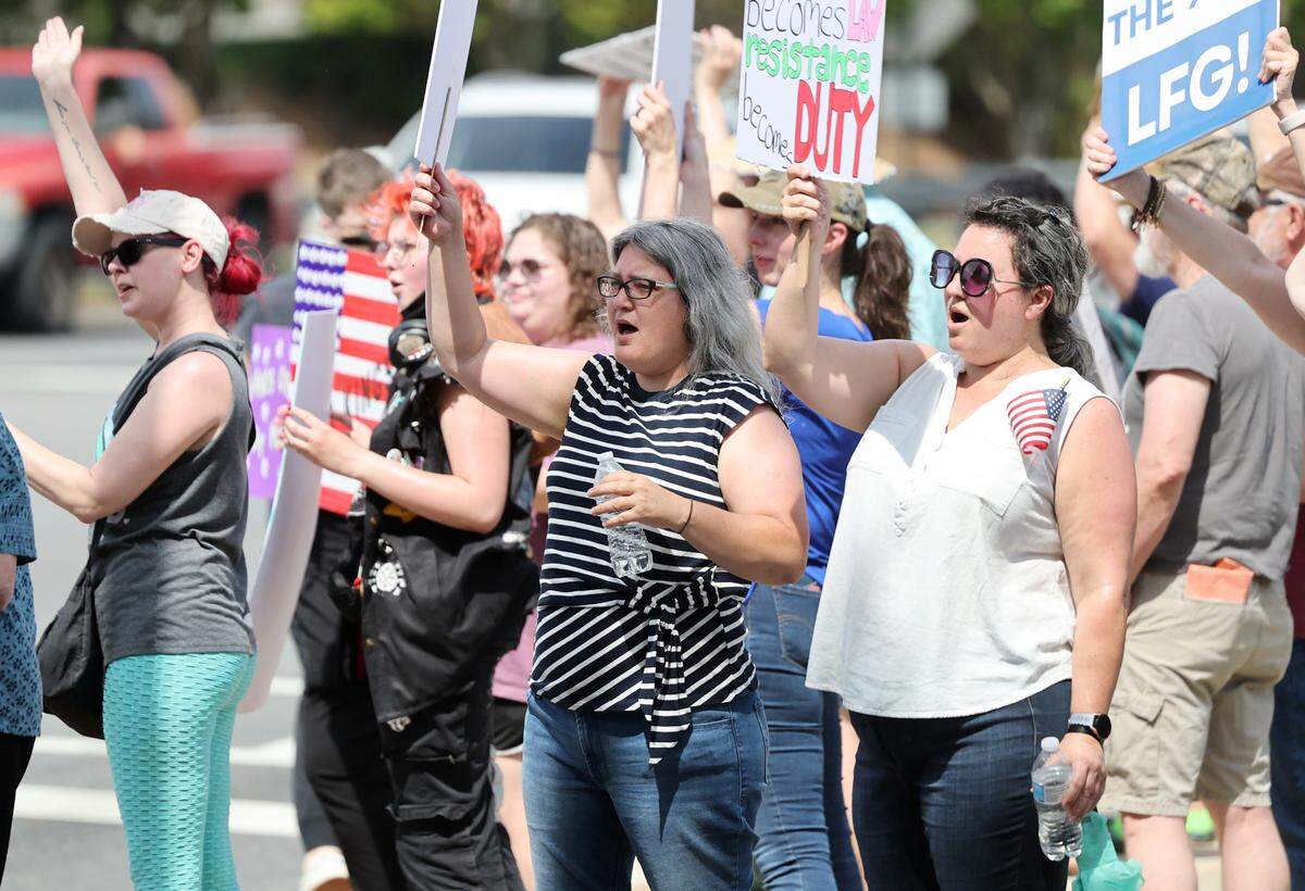 Demonstrators with York County Rising protest President Trump and his policies Sautrday in downtown Rock Hill.