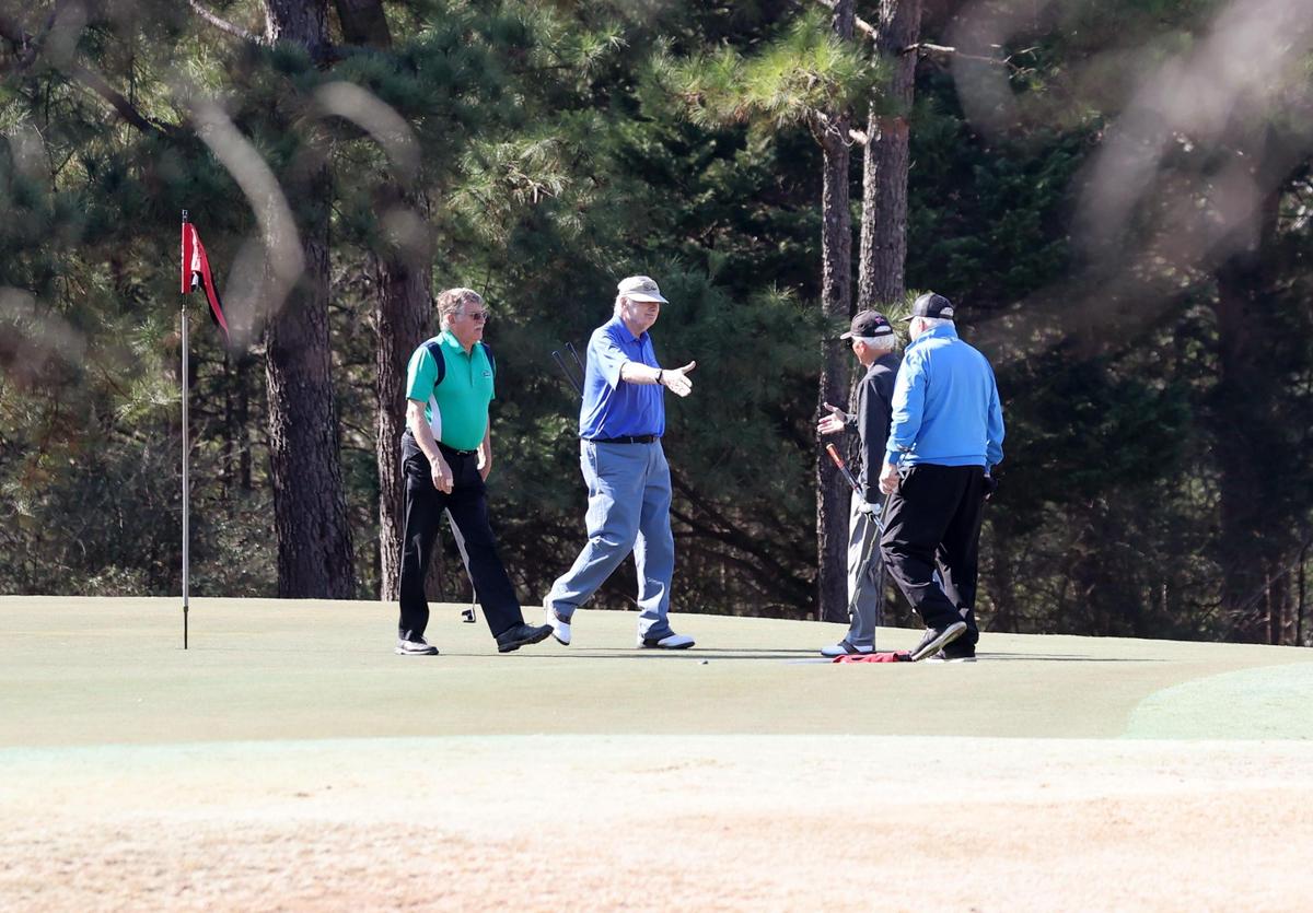 Golfers take advantage of warmer weather Thursday to play a round of golf at the Tega Cay Country Club.