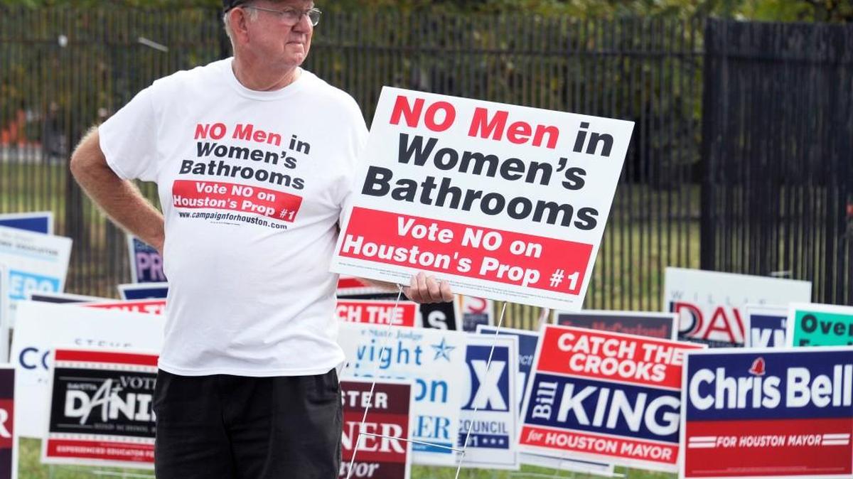 A demonstrator holds a sign against the Houston Equal Rights Ordinance outside an early voting center in Houston last year.