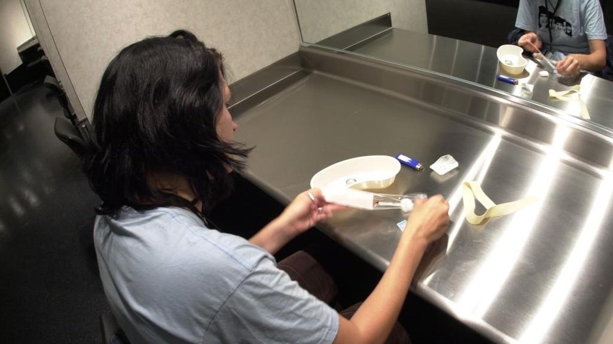 A woman prepares to use heroin at an “injection site” in Vancouver; the mayor of Ithaca, N.Y., is proposing such a site for his city, which has been hard hit by the heroin epidemic.