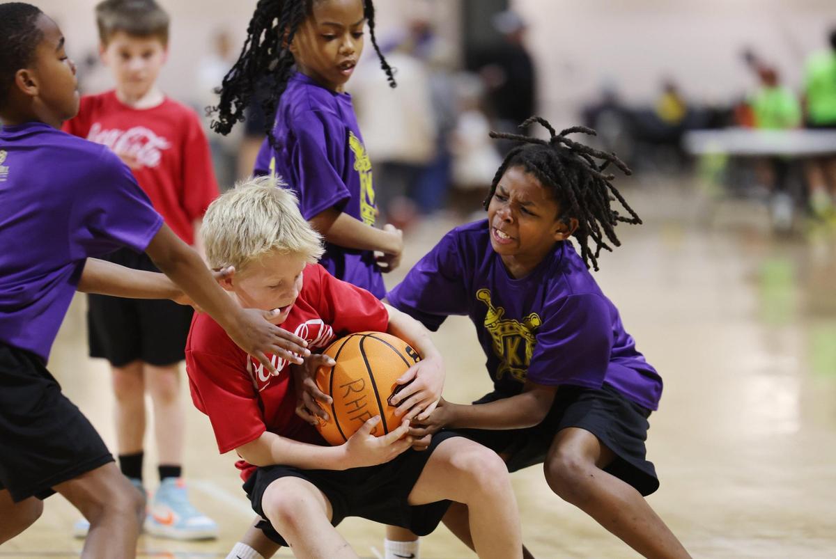 Children fight for control of the ball Wednesday at a City of Rock Hill Parks, Recreation and Tourism basketball game at the Sports and Event Center. York County could start charging people in Rock Hill, Fort Mill and other municipalities a recreation tax while also slashing money to fund municipal recreation departments.