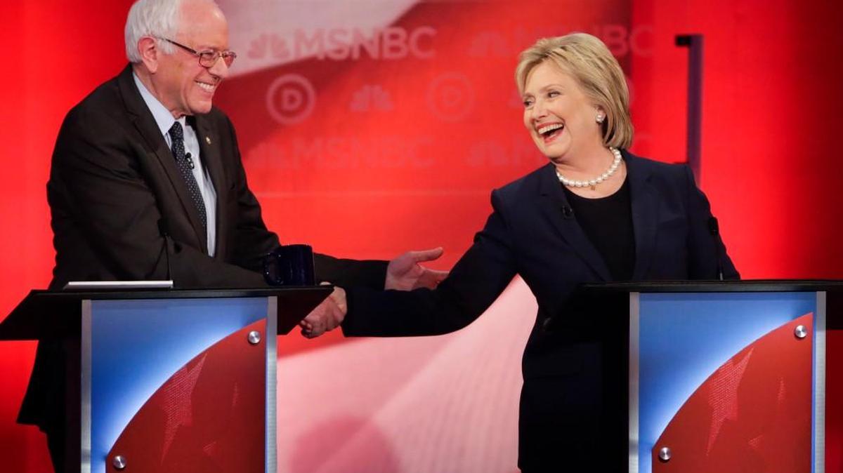 Democratic presidential candidates Bernie Sanders and Hillary Clinton shake hands during a Democratic presidential primary debate at the University of New Hampshire on Thursday.
