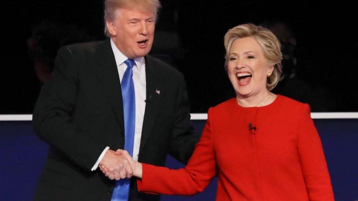 Republican presidential nominee Donald Trump and Democratic presidential nominee Hillary Clinton shake hands after the first presidential debate.