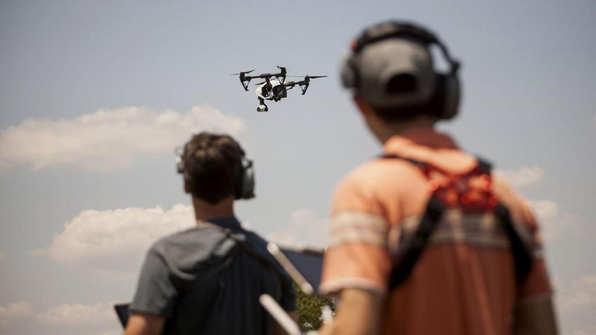 Mike Ferguson, chief pilot at AeroCine (left) and Jeff Brink, director of Flight-Ops and co-founder of AeroCine, operate a DJI Inspire drone at Calvert Vaux Park in Brooklyn, New York.