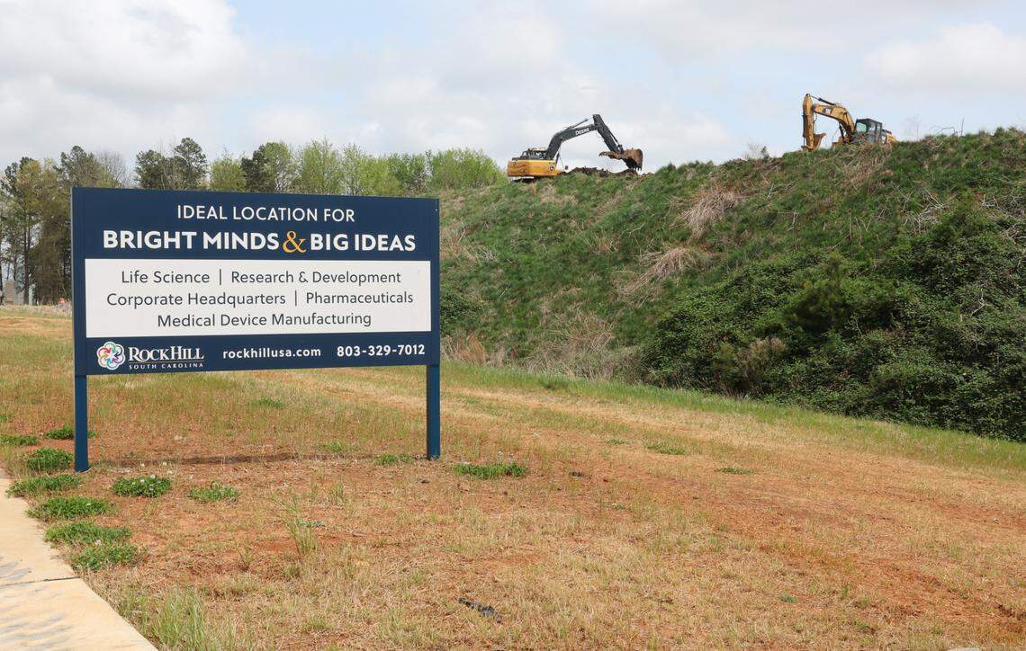 In this file photo, a crew works at the failed site of the Panthers training center in Rock Hill near a sign advertising the site for various industry. The city is looking to sell a portion of that property now.