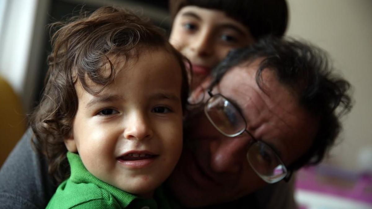 
Syrian refugee Fadi Adris, center, and his sons Abdel Hamid, rear, and Osama are adjusting to life in Chicago. 
